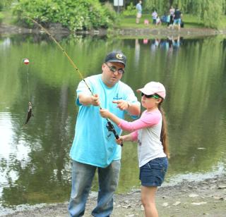 Man helping girl to fish