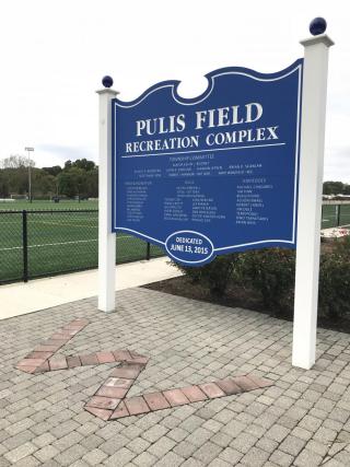 Royal Blue sign with the words Pulis Field Recreation Complex, listing donors to the project